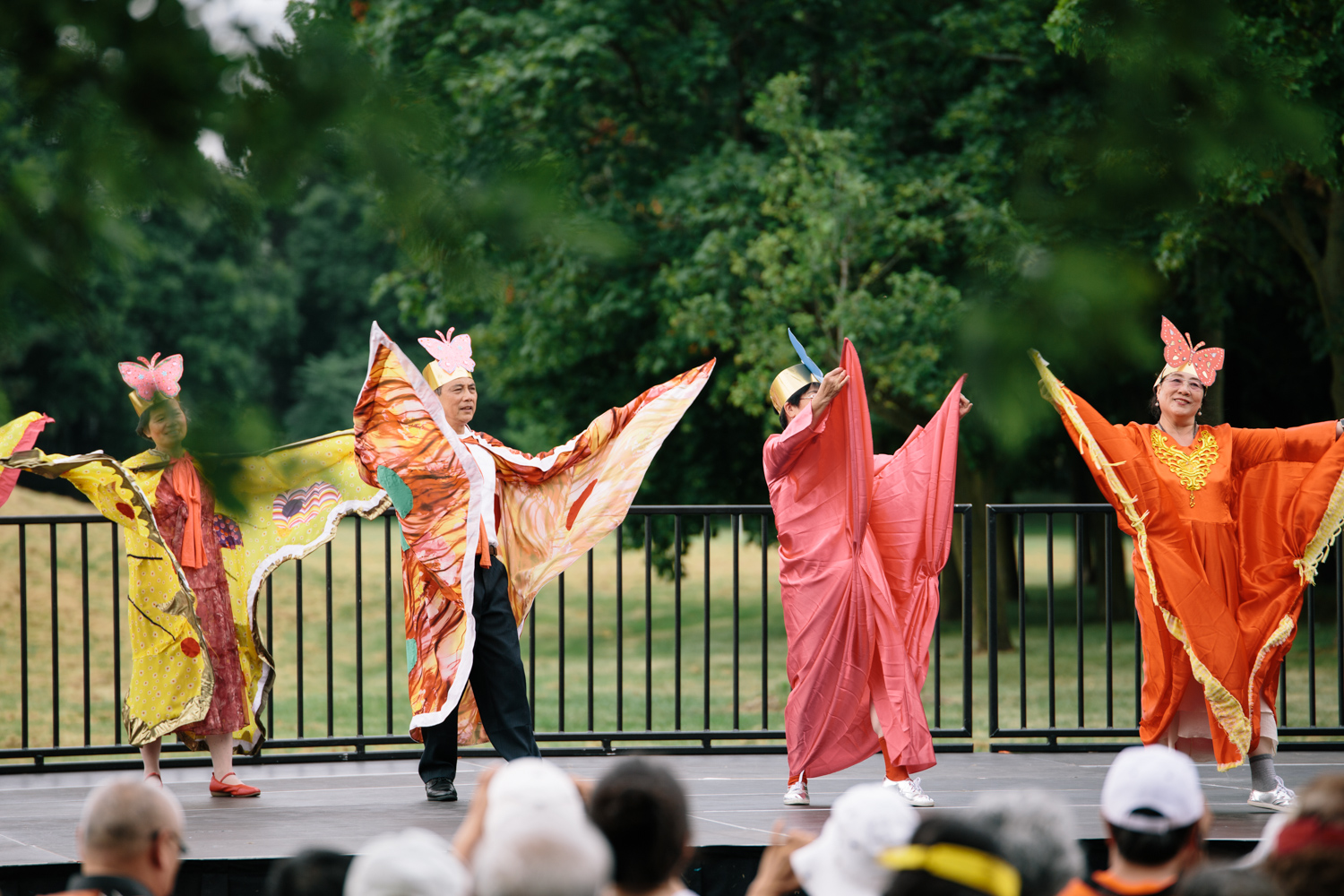 Four women in colourful draped costumes dance on stage.