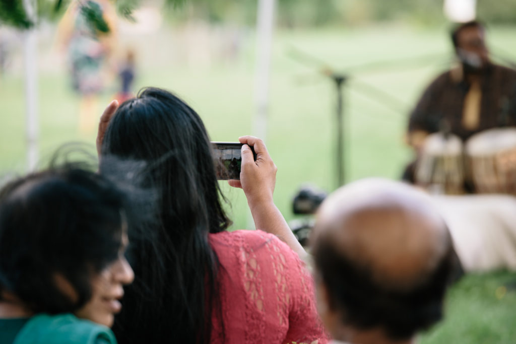 An audience member takes a photo during a performance.