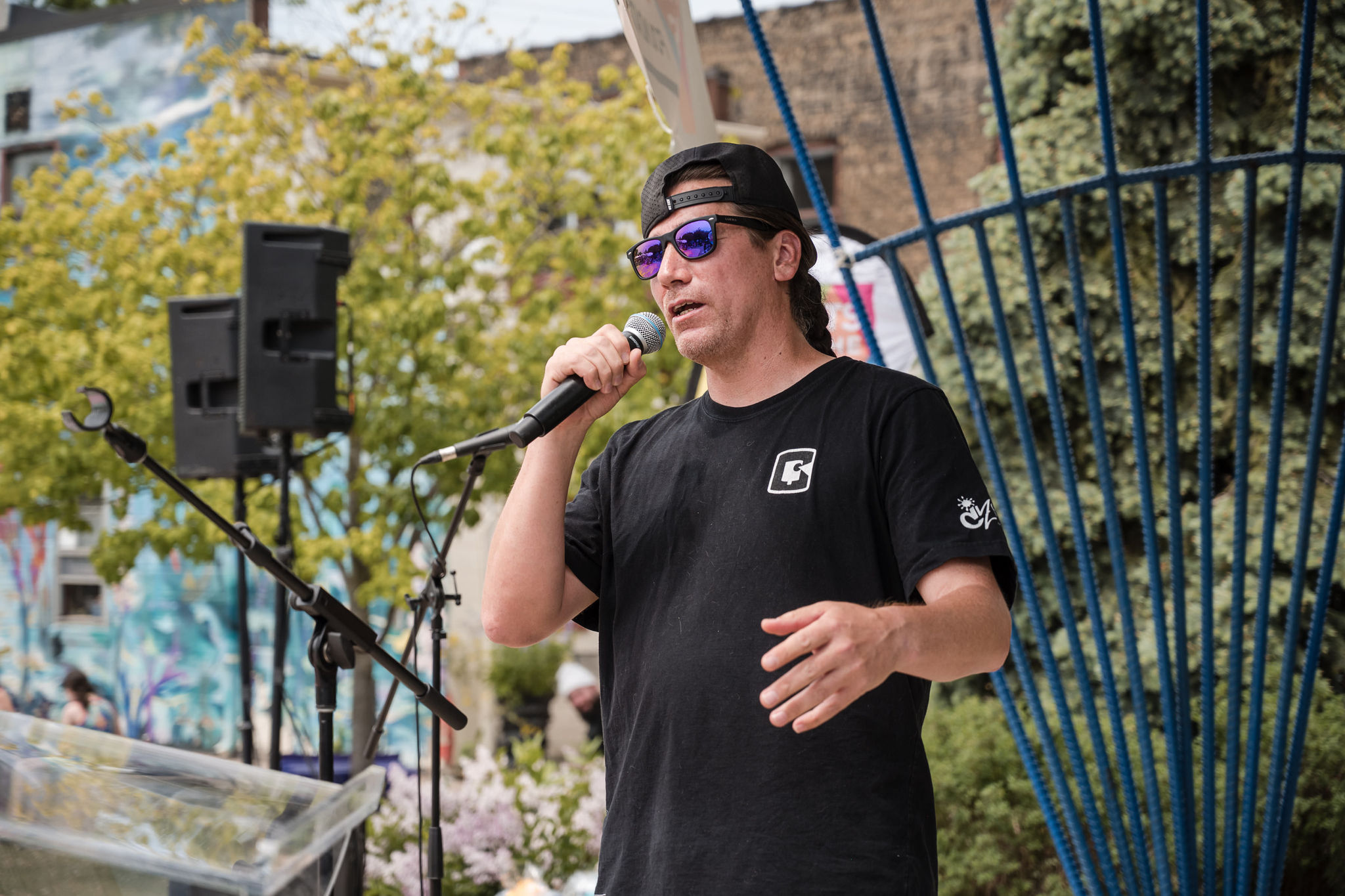 Indigenous artist and rapper Que Rock speaks into a microphone.
