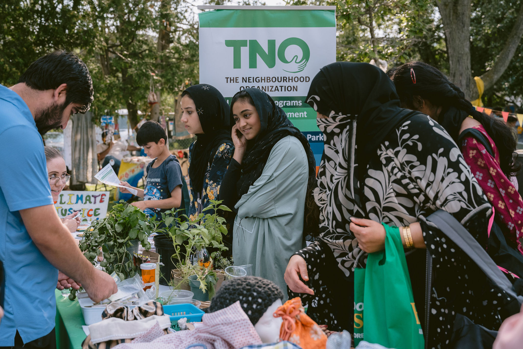 Locals look at The Neighbourhood Organization’s (TNO) booth