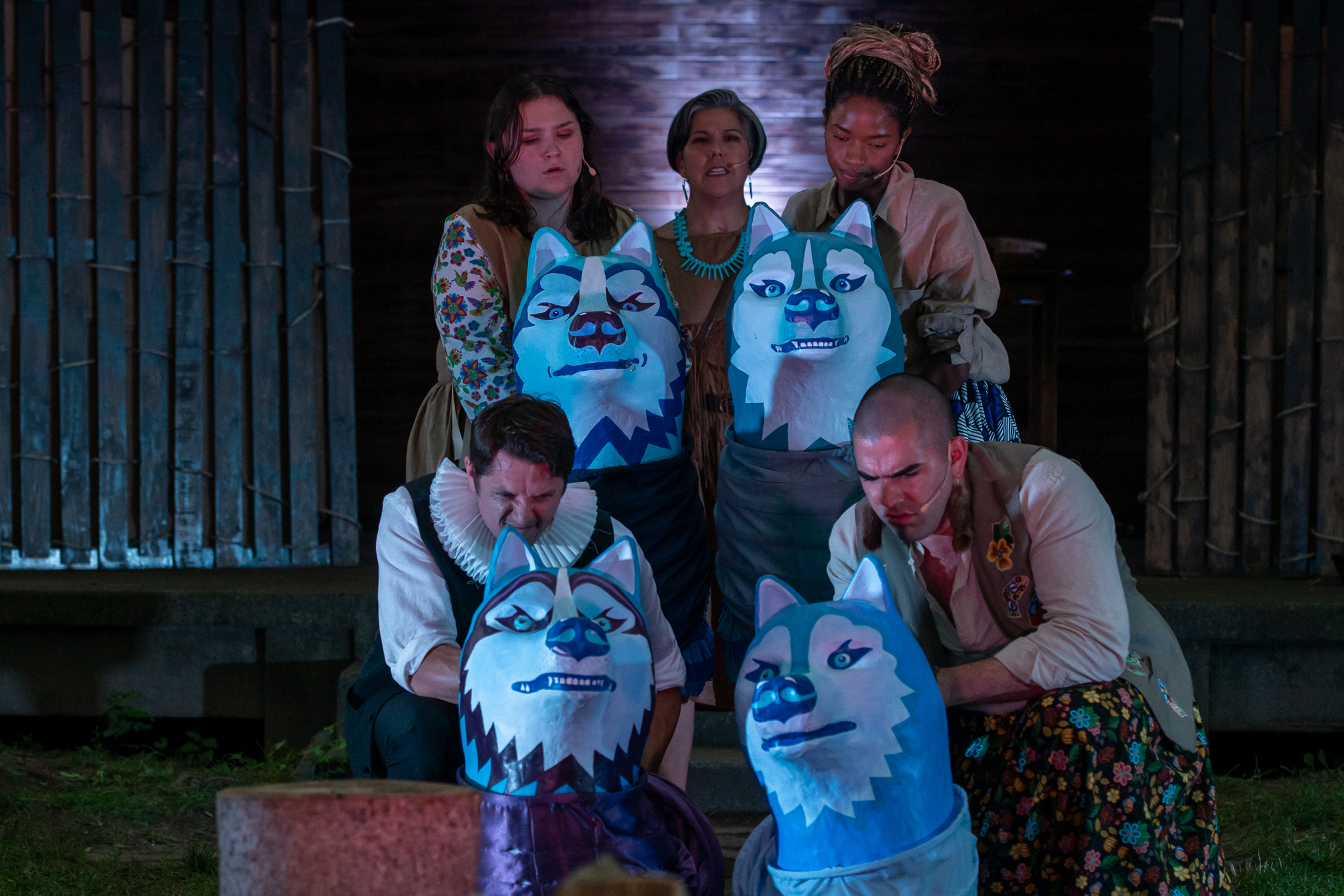 Otîhêw, portrayed by Nicole Joy-Fraser, stands with four actors, Brefny Caribou, Jewell Bowry, Jonathan LeRose, and Raymond Jordan Johnson-Brown, holding blue and white wolf puppets.