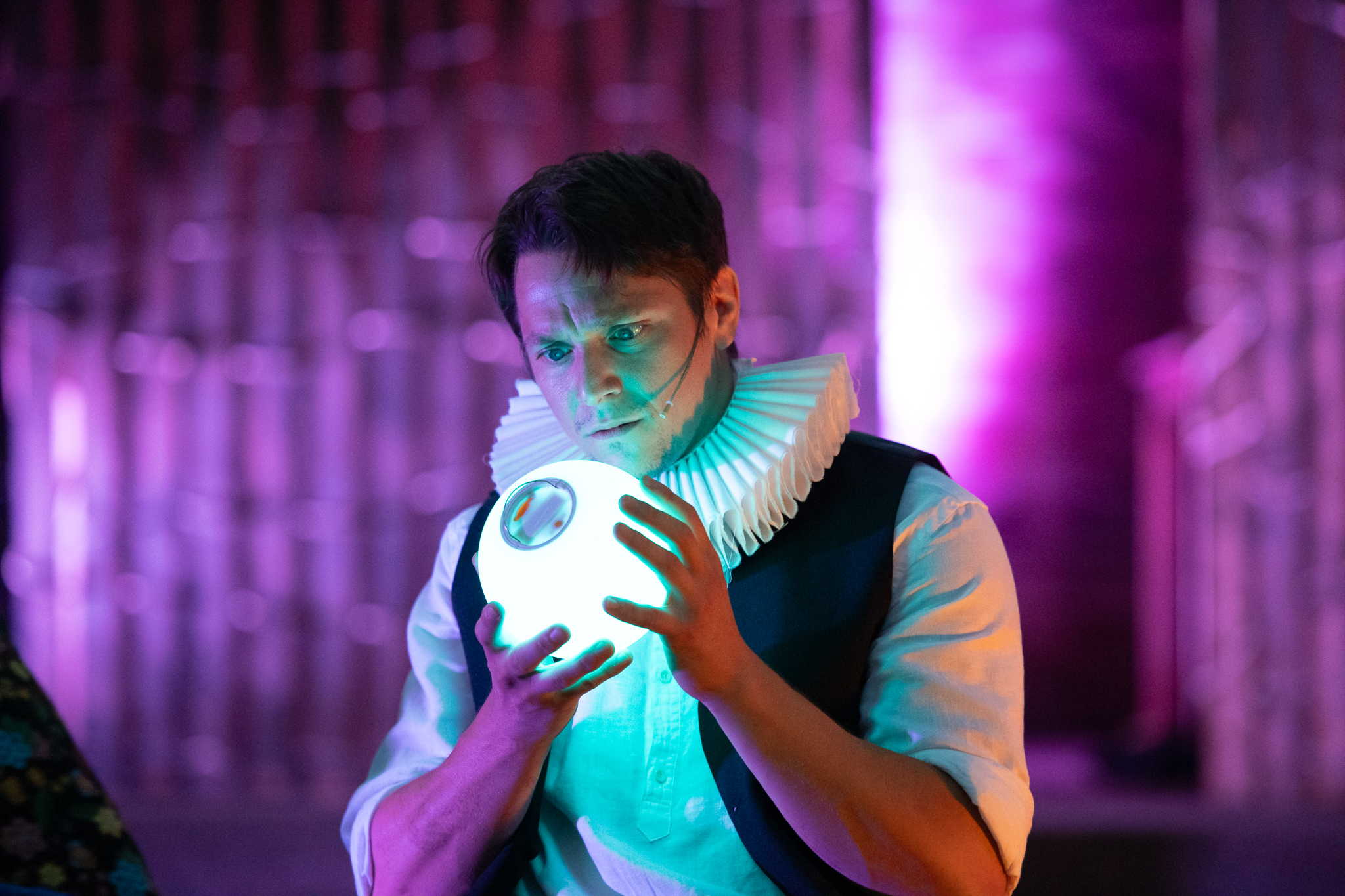 Hamish, portrayed by Jonathan LeRose, is transfixed by a ball of light in his hands.