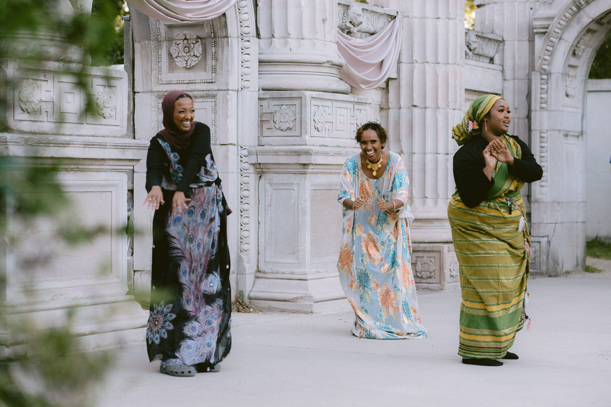 Festival Organizer Warda Youssouff and two others dance on an outdoor stage.